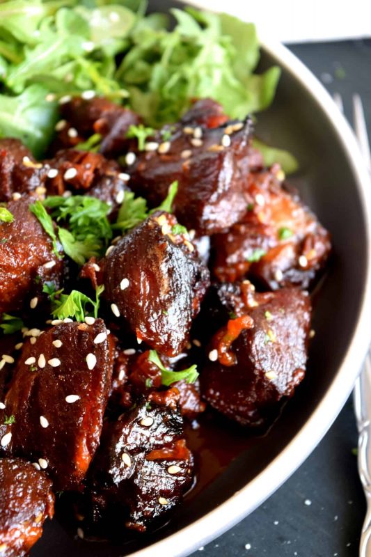 Moist and tender, with charred bits too, these Honey Garlic Baked Pork Bites are delicious and easy to prepare. Despite the long cooking time, this main is perfect for a family dinner anytime. Sweet and garlicky, with an optional kick of spice and heat. Yum! #pork #baked #bites #honey #garlic