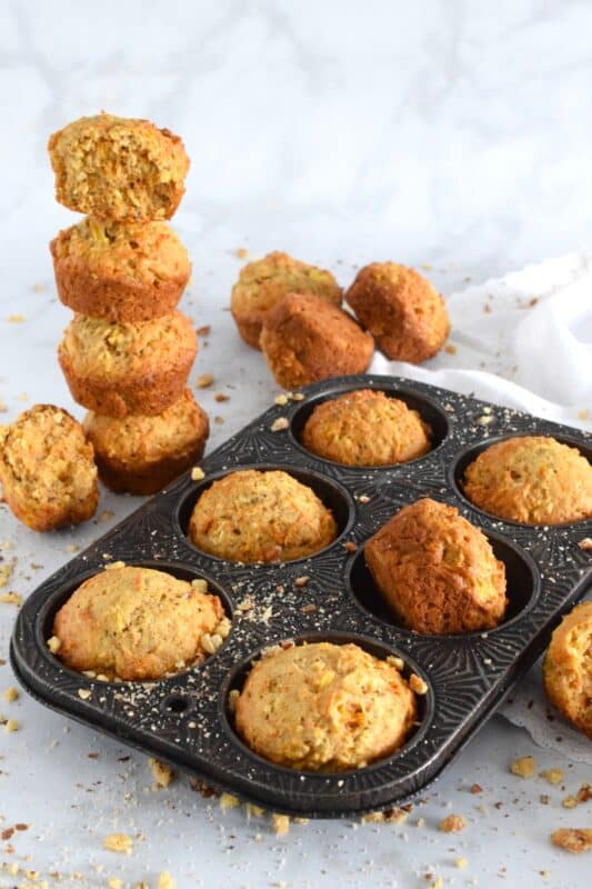 Morning Glory Muffins are prepared with coconut, walnuts, pineapple, apples and carrots. I think of them as a spiced, fruity, carrot cake without the cream cheese frosting! The name suggests that these are meant to be a breakfast item, and they certainly are great for that, but I happen to think they are good any time of the day - especially this homemade version! #morningglory #muffins #carrot #pineapple #coconut #brunch #apple