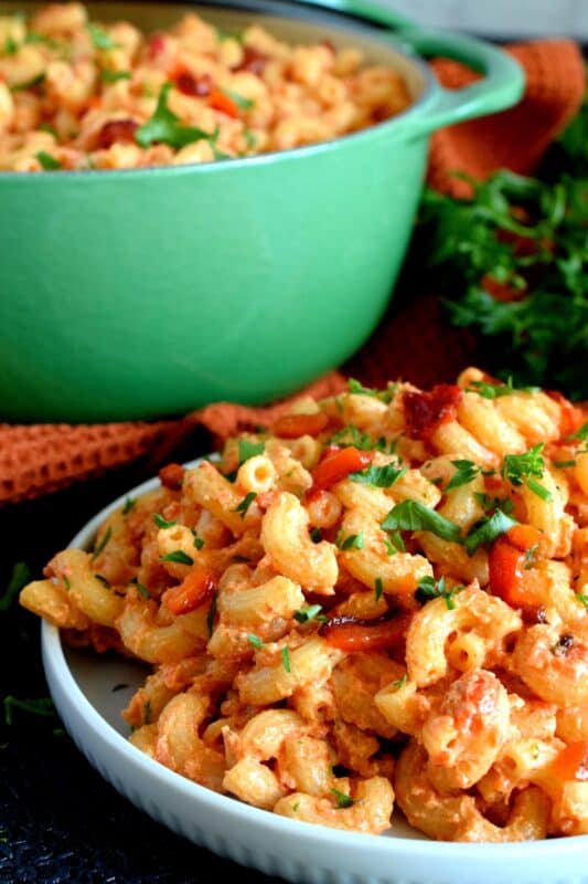 Creamy, smoky, cheesy, and home-style – that’s the essence of Roasted Red Pepper and Goat Cheese Pasta. A weeknight dinner option that never disappoints! Made with a splash of white wine, this rustic pasta can easily pass as a gourmet dinner option for your guests. #goatcheese #whitewine #pasta #roastedredpepper