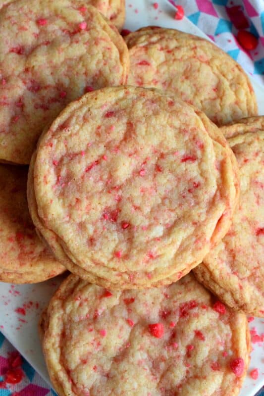 Not all great cookies are soft and chewy.  Valentine Cinnamon Heart Cookies are thin and crispy with a soft, sweet center. And, they're packed full of everyone's favourite cinnamon candy! Make a batch for your special someone today! #valentine #cinnamon #heart #candy #cookies