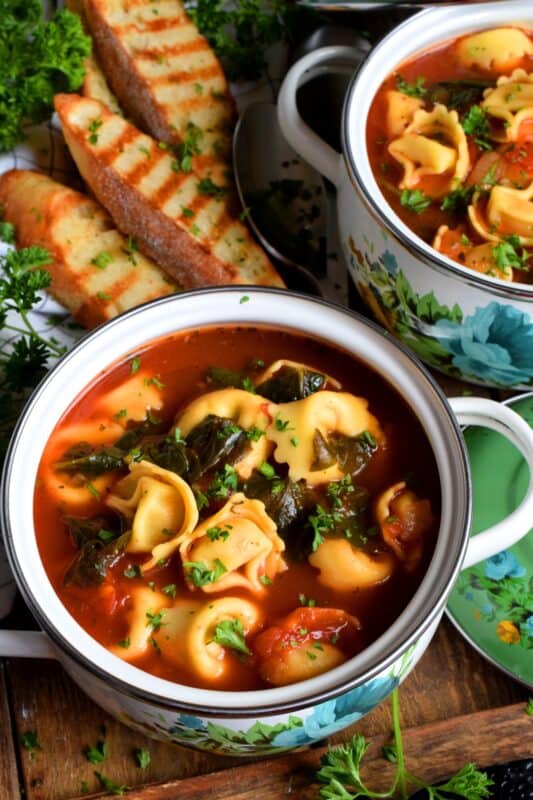 This soup is a complete meal! Not only is it hearty and filling, it's also very delicious! Tomato Tortellini Soup is a wholesome and nutritious meal that is quite easy to prepare and only takes about forty minutes from start to finish! It's loaded with aromatics and fresh spinach too! #soup #pasta #tomato #tortellini