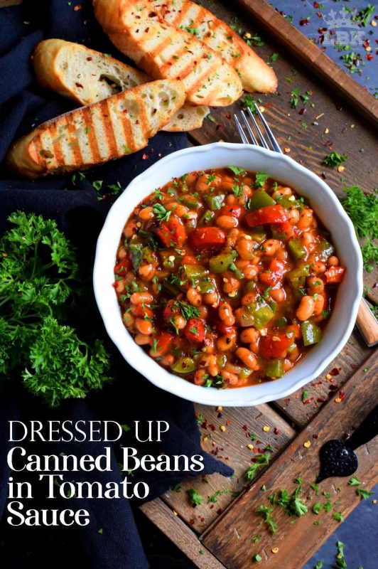 With the help of some fresh veggies and a few spices and herbs, this recipe uses plain canned beans in tomato sauce and transforms it so that it is dressed up and brand new!#canned #beans #tomato #sauce #doctored #dressedup