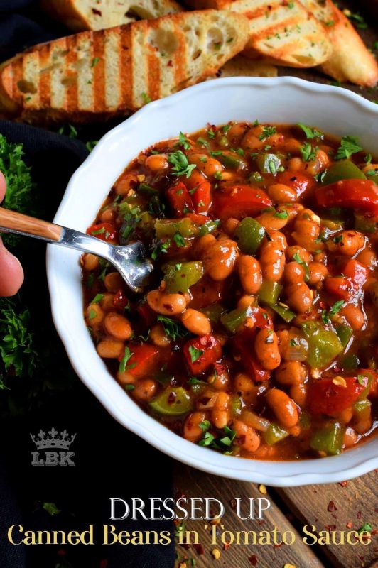With the help of some fresh veggies and a few spices and herbs, this recipe uses plain canned beans in tomato sauce and transforms it so that it is dressed up and brand new!#canned #beans #tomato #sauce #doctored #dressedup