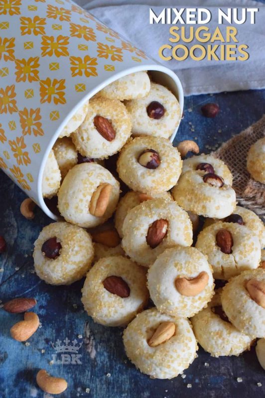 Made with almonds, cashews, and hazelnuts, Mixed Nut Sugar Cookies are a soft, melt-in-your-mouth type of cookie with a crunchy nut baked right on top. Try eating just one! #sugar #cookies #baking #nuts #almonds #cashews #hazelnuts