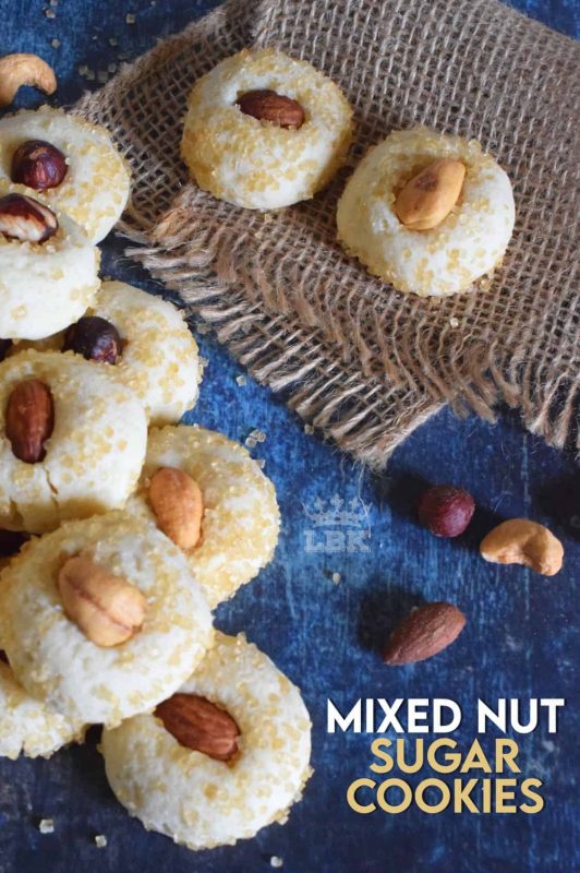 Made with almonds, cashews, and hazelnuts, Mixed Nut Sugar Cookies are a soft, melt-in-your-mouth type of cookie with a crunchy nut baked right on top. Try eating just one! #sugar #cookies #baking #nuts #almonds #cashews #hazelnuts