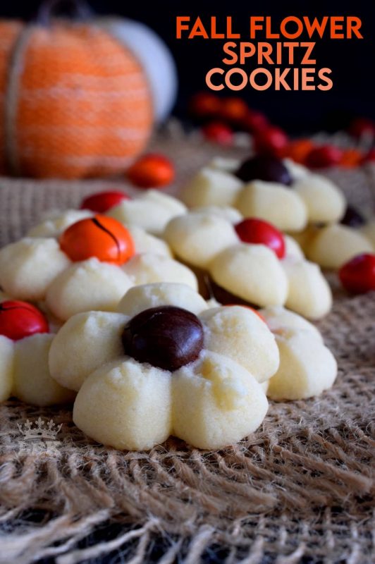 With the help of M&M candy and a cookie press, these spritz cookies look very much like a fall flower arrangement when piled high onto a serving plate. #thanksgiving #fall #cookies #press #spritz #M&Ms