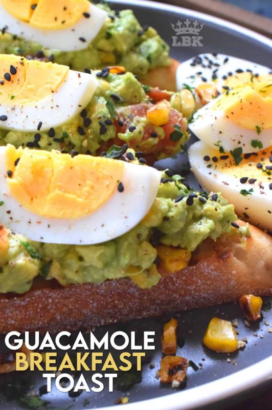 Guacamole Breakfast Toast makes for a full and hearty breakfast. Toasted bread piled with avocado, corn, and tomatoes; topped with wedges of hard boiled egg. A perfectly delicious meal anytime of the day! #avocado #guacamole #breakfast #toast #bread