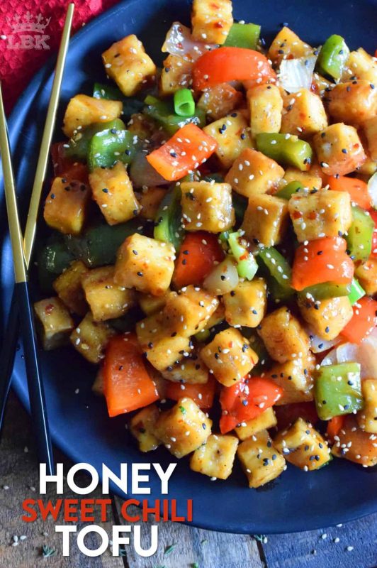Start with a baked crispy tofu and toss it in a delicious sauce with fresh bell peppers and onions. Honey Sweet Chili Tofu is a robust and satisfying vegetarian main! #tofu #sweetchili #spicy #peppers #vegetarian