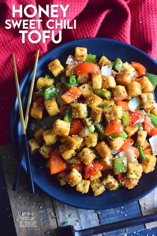 Start with a baked crispy tofu and toss it in a delicious sauce with fresh bell peppers and onions. Honey Sweet Chili Tofu is a robust and satisfying vegetarian main! #tofu #sweetchili #spicy #peppers #vegetarian