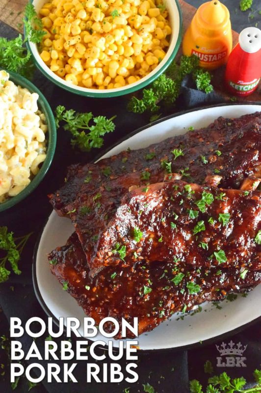 Bourbon Barbecue Pork Ribs are fall-off-the-bone tender. They are slow baked in the oven and basted with a thick and glossy, spicy and sweet, partially homemade bourbon barbecue sauce. Half a rack per person sounds right, yes!? #porkribs #bourbon #barbecue #oven #ribs