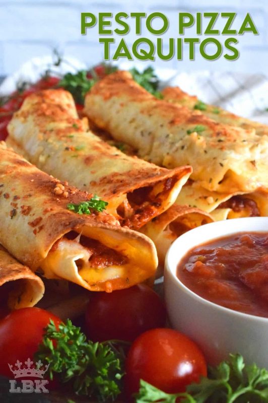 Prepared with homemade sun dried tomato pesto and lots of melted, gooey cheese, Pesto Pizza Taquitos are baked in the oven with a garlic and parmesan topping. Sounds irresistible, right? #taquitos #vegetarian #pesto #pizza #sundriedtomato