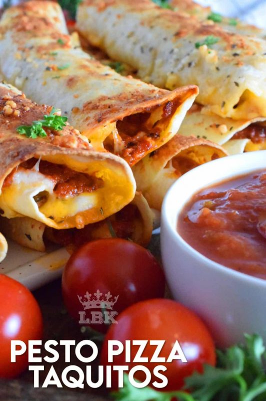 Prepared with homemade sun dried tomato pesto and lots of melted, gooey cheese, Pesto Pizza Taquitos are baked in the oven with a garlic and parmesan topping. Sounds irresistible, right? #taquitos #vegetarian #pesto #pizza #sundriedtomato