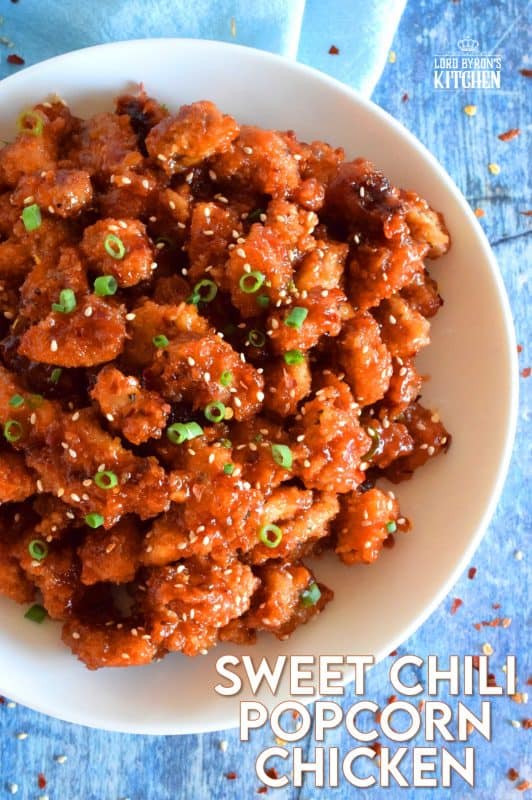 Marinated thigh meat, coated in panko and then baked until crispy, Sweet Chili Popcorn Chicken is then tossed in a homemade sauce which can be as mild or as hot as you prefer. It's sticky, sweet, spicy, moist, and tender! #popcornchicken #sweetheat #sweetchilithai #thai #bakedchicken #spicy #sticky