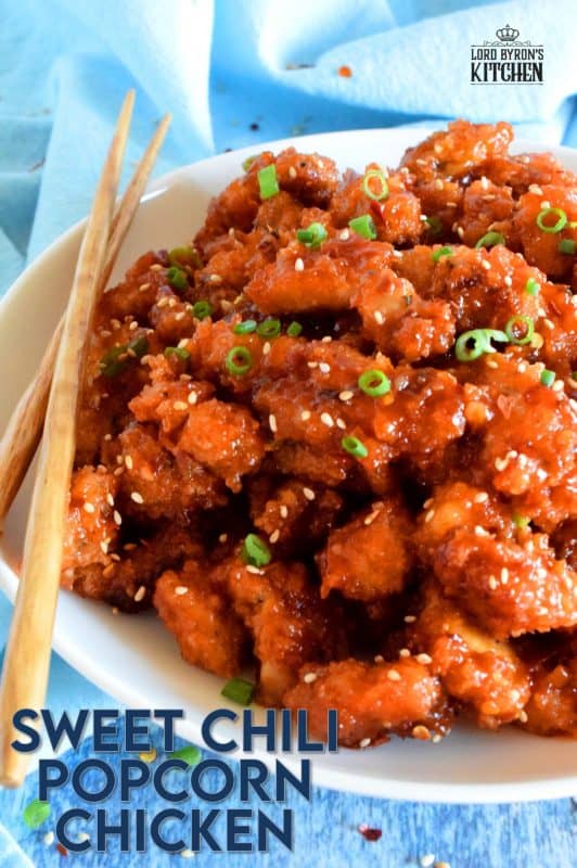 Marinated thigh meat, coated in panko and then baked until crispy, Sweet Chili Popcorn Chicken is then tossed in a homemade sauce which can be as mild or as hot as you prefer. It's sticky, sweet, spicy, moist, and tender! #popcornchicken #sweetheat #sweetchilithai #thai #bakedchicken #spicy #sticky