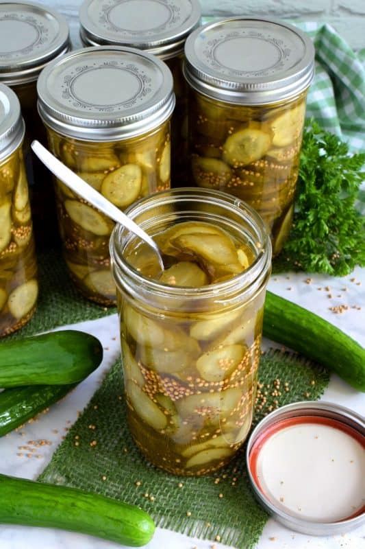 Every sandwich needs a pickle! Preserve your own Sweet Sandwich Pickles using a water bath canning method - easy and inexpensive too! Both zucchini and cucumbers will work in this recipe! #pickles #canned #sweet #preserves