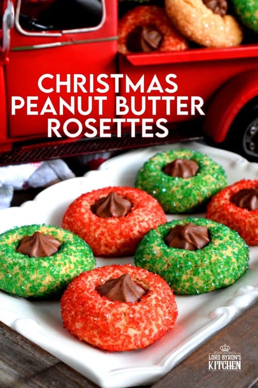 A light and fluffy peanut butter cookie with a milk chocolate rosette center, which has been rolled in sanding sugar. Christmas Peanut Butter Rosettes will add lots of festive colour and flavour to your holiday baking. These are a great addition to a cookie exchange! #christmas #holiday #baking #peanutbutter #rosette #chocolate #cookies