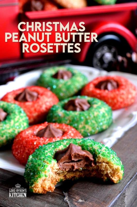 A light and fluffy peanut butter cookie with a milk chocolate rosette center, which has been rolled in sanding sugar. Christmas Peanut Butter Rosettes will add lots of festive colour and flavour to your holiday baking. These are a great addition to a cookie exchange! #christmas #holiday #baking #peanutbutter #rosette #chocolate #cookies