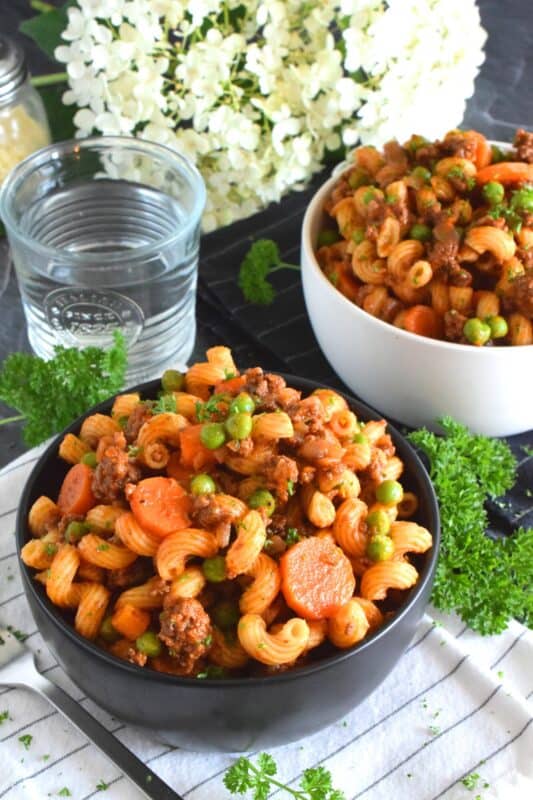 Savoury Ground Beef Pasta is a wonderful fall-inspired dish which is prepared in less than 45 minutes. With ingredients like beef, carrots, onions, tomatoes, peas, and thyme, who could resist? This is not your average ground beef pasta; this is hearty, comforting, and perfect for the cooler months ahead. #groundbeef #pasta #beef #family