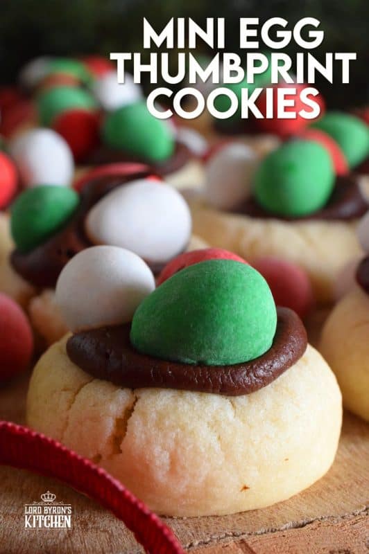 These are made using a classic thumbprint cookie dough, which is stuffed with a creamy chocolate frosting, and topped with mini eggs. There's no doubt that Christmas Mini Egg Thumbprint Cookies will be the first cookie to disappear from your cookie platter! #minieggs #cadbury #hershey #christmas #holiday #baking #thumbprint #cookies