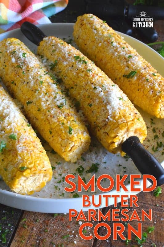 Something magical happens to food prepared in a smoker that cannot be replicated with any other cooking device. Smoked Butter Parmesan Corn is evidence of that! Fresh corn is slow smoked with apple wood and coated with melted butter, grated parmesan, black pepper, and an optional dusting of cayenne! #smoker #smokingrecipes #corn #cornonthecob #backyardsmoking #charcoal