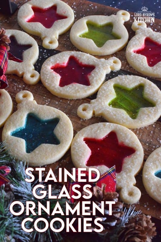 These beautiful Stained Glass Ornament Cookies are made with an easy rolled cookie dough, some glistening sanding sugar, and your favourite flavour of crushed Jolly Ranchers candy. #stainedglass #christmas #holiday #baking #cookies #edible #ornaments #cookiecutters