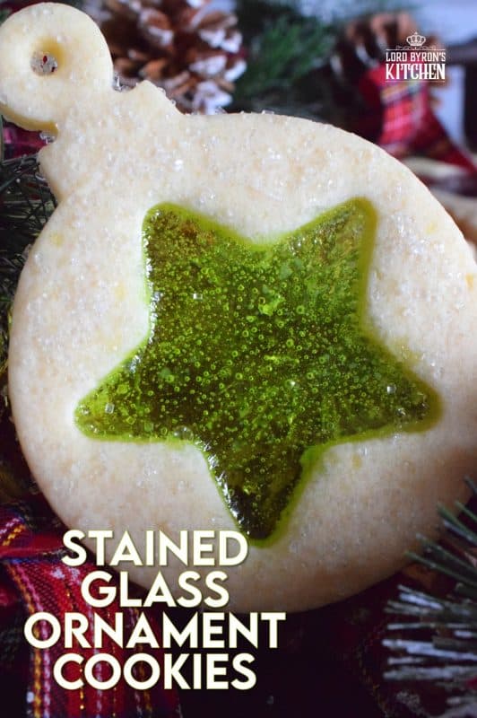 These beautiful Stained Glass Ornament Cookies are made with an easy rolled cookie dough, some glistening sanding sugar, and your favourite flavour of crushed Jolly Ranchers candy. #stainedglass #christmas #holiday #baking #cookies #edible #ornaments #cookiecutters
