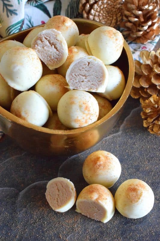 The base of this truffle is prepared with melted white chocolate, eggnog, and cream cheese. With the addition of confectioner's sugar, cinnamon, nutmeg, and rum, Holiday Eggnog Truffles are the most Christmassy thing you'll taste this season! #christmas #holiday #eggnog #truffles #chocolate #nobake
