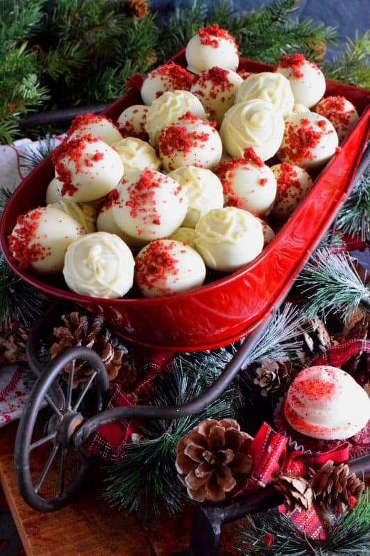 Looking for a quick and easy, yet affordable and delicious truffle recipe? How about these Red Velvet Cupcake Truffles? Use deconstructed cupcakes to make the centers and then dip them into melted white chocolate! You never have to tell anyone they weren't prepared from scratch! Who's going to know otherwise?? #redvelvet #chocolate #truffles #cupcakes #christmas #holiday #nobake