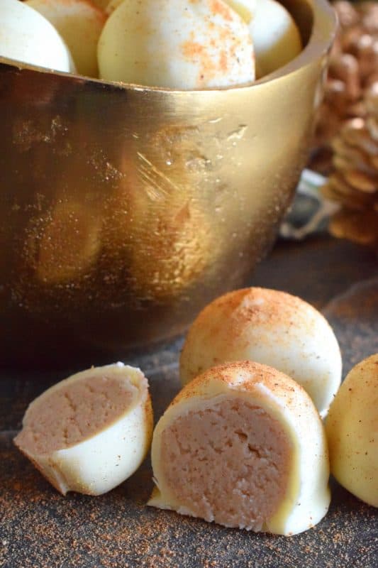 The base of this truffle is prepared with melted white chocolate, eggnog, and cream cheese. With the addition of confectioner's sugar, cinnamon, nutmeg, and rum, Holiday Eggnog Truffles are the most Christmassy thing you'll taste this season! #christmas #holiday #eggnog #truffles #chocolate #nobake