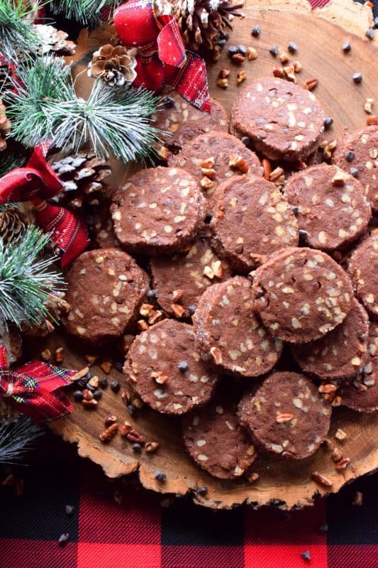 Pecan Shortbread Slices are one of those cookies you can make long in advance. They are rolled into a log, well wrapped, and can be refrigerated or frozen until you feel like baking. They are packed with toasted pecans and prepared with good cocoa and mini chocolate chips for extra chocolatey flavour. #shortbread #christmas #holiday #baking #cookies #chocolate #freezer #slices
