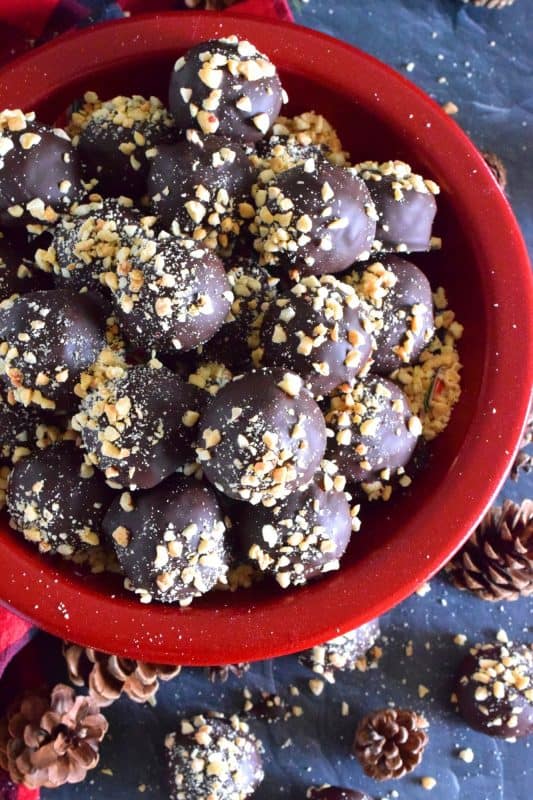Dipped in melted milk chocolate and topped with chopped, salted peanuts, Crispy Peanut Butter Truffles are a delicious confection that not only melts in your mouth, but the inside has an airy and crispy bite from the Rice Krispies Cereal, peanuts, and chocolate chips. This truffle is for the serious peanut butter and chocolate lover! #christmas #holiday #nobake #truffles #peanutbutter #chocolate #ricekrispies