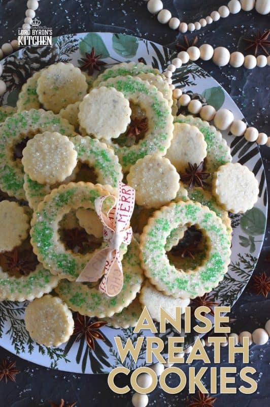 These tender, flaky, yet crisp Anise Wreath Cookies are prepared with a basic rolled cookie dough, but flavoured with crushed anise seeds. Sprinkled with green sanding sugar, these licorice-flavoured cookies are a great addition to any holiday cookie exchange or cookie platter! #christmas #holiday #baking #cookies #wreath #anise