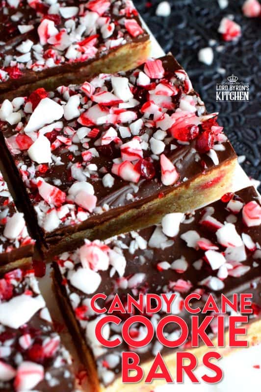 Soft and moist Candy Cane Cookie Bars, which are baked in a sheet pan, then smeared with melted chocolate, and topped with more crushed candy canes, is bound to be a new holiday favourite! These make holiday baking fun and easy! #candycane #cookies #cookiebars #christmas #holiday #baking
