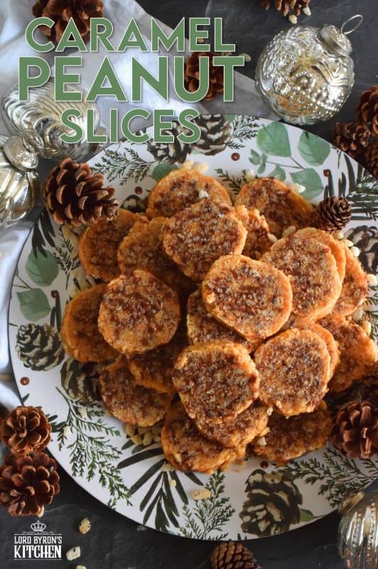 Caramel Peanut Slices are a no-bake confection consisting of caramel, peanut butter, rice krispies cereal, chocolate, and chopped peanuts. Working in layers, it is rolled into a log and chilled until set. The log is cut into slices before being served. These cookies are irresistible and one of my all-time favourite Christmas treats! #caramel #caramellogs #christmas #holiday #nobake #cookies #peanutbutter