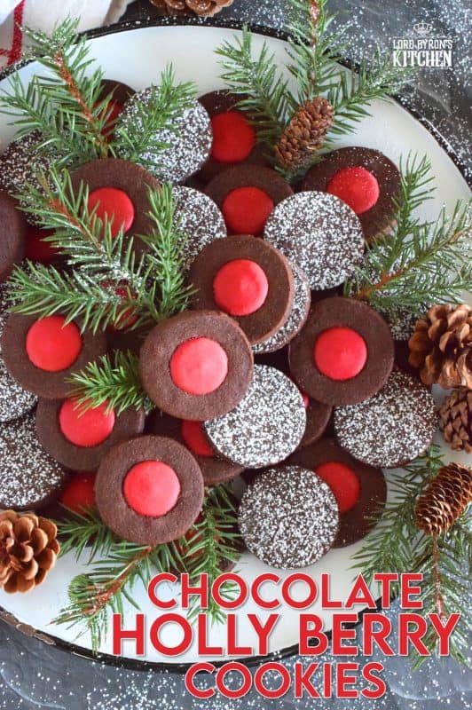Christmas baking is never complete without a cookie recipe or two that requires one to break out their stash of cookie cutters. In the case of these Chocolate Holly Berry Cookies, it's just a round cookie cutter, but it still feels Christmassy to use any shape! These cookies have a crispy, chocolaty cookie base with a bright red holly berry center - aren't they festive? #christmas #holiday #baking #cookies #chocolate #shortbread #holly