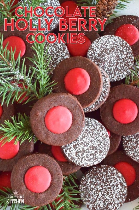 Christmas baking is never complete without a cookie recipe or two that requires one to break out their stash of cookie cutters. In the case of these Chocolate Holly Berry Cookies, it's just a round cookie cutter, but it still feels Christmassy to use any shape! These cookies have a crispy, chocolaty cookie base with a bright red holly berry center - aren't they festive? #christmas #holiday #baking #cookies #chocolate #shortbread #holly