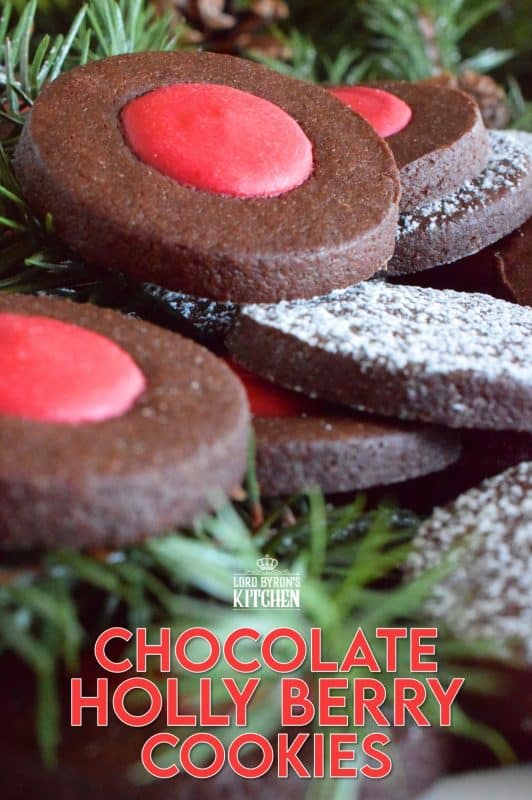 Christmas baking is never complete without a cookie recipe or two that requires one to break out their stash of cookie cutters. In the case of these Chocolate Holly Berry Cookies, it's just a round cookie cutter, but it still feels Christmassy to use any shape! These cookies have a crispy, chocolaty cookie base with a bright red holly berry center - aren't they festive? #christmas #holiday #baking #cookies #chocolate #shortbread #holly