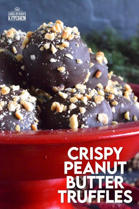 Dipped in melted milk chocolate and topped with chopped, salted peanuts, Crispy Peanut Butter Truffles are a delicious confection that not only melts in your mouth, but the inside has an airy and crispy bite from the Rice Krispies Cereal, peanuts, and chocolate chips. This truffle is for the serious peanut butter and chocolate lover! #christmas #holiday #nobake #truffles #peanutbutter #chocolate #ricekrispies