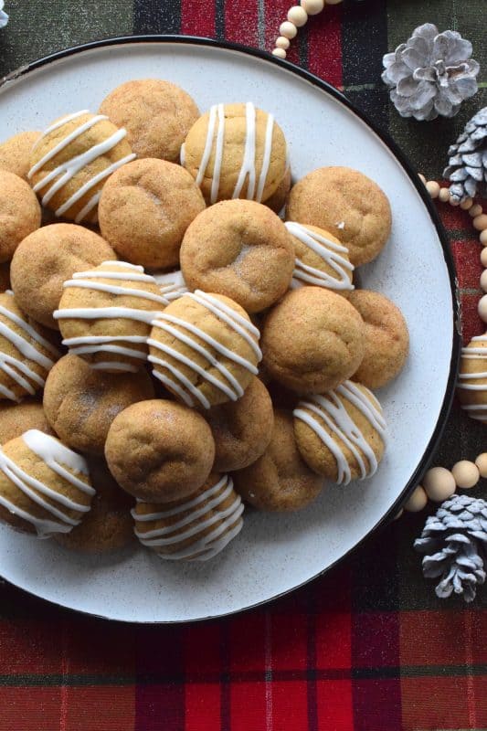 A soft, chewy cookie prepared with sour cream and familiar, warming, Christmastime spices. Spiced Sour Cream Cookies are loaded with cinnamon, cloves, ginger, and nutmeg too, which makes them a very comforting and cozy confection! The drizzled glaze is completely optional too! #christmas #holiday #baking #spiced #cookies #chewycookies