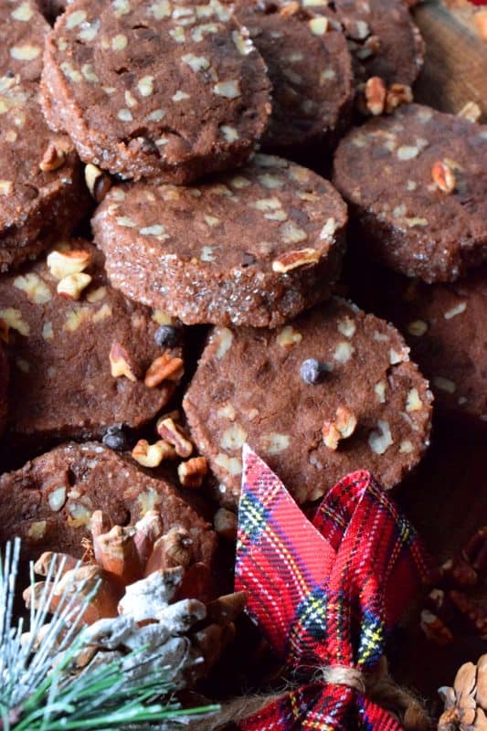 Pecan Shortbread Slices are one of those cookies you can make long in advance. They are rolled into a log, well wrapped, and can be refrigerated or frozen until you feel like baking. They are packed with toasted pecans and prepared with good cocoa and mini chocolate chips for extra chocolatey flavour. #shortbread #christmas #holiday #baking #cookies #chocolate #freezer #slices