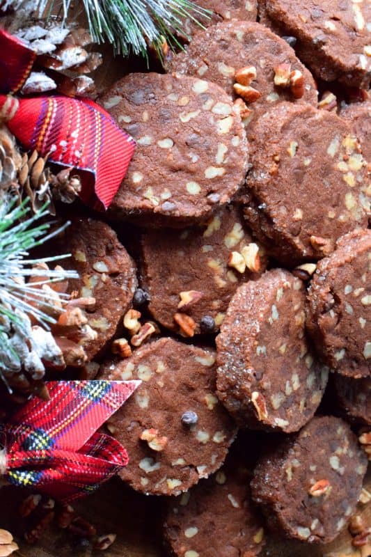 Pecan Shortbread Slices are one of those cookies you can make long in advance. They are rolled into a log, well wrapped, and can be refrigerated or frozen until you feel like baking. They are packed with toasted pecans and prepared with good cocoa and mini chocolate chips for extra chocolatey flavour. #shortbread #christmas #holiday #baking #cookies #chocolate #freezer #slices