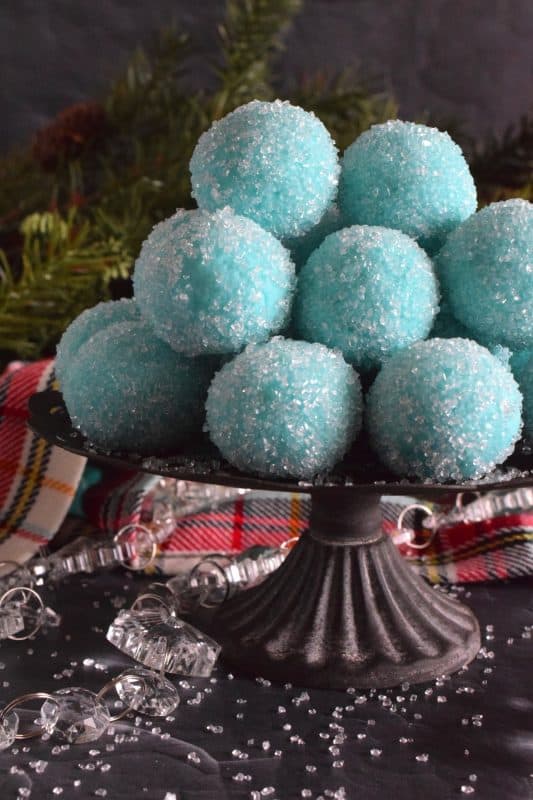 Blue Christmas Truffles are prepared with a white chocolate ganache base. The beautiful colour comes from the addition of blue curacao, which creates a warming sensation as these melt in your mouth. White chocolate and a hint of citrus is what you get with these treats! #bluechristmas #truffles #nobake #ganache #whitechocolate #curacao