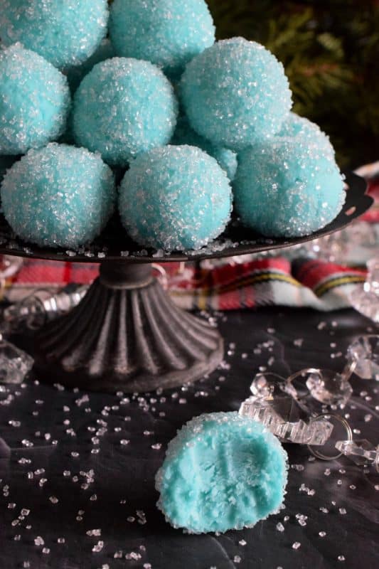 Blue Christmas Truffles are prepared with a white chocolate ganache base. The beautiful colour comes from the addition of blue curacao, which creates a warming sensation as these melt in your mouth. White chocolate and a hint of citrus is what you get with these treats! #bluechristmas #truffles #nobake #ganache #whitechocolate #curacao
