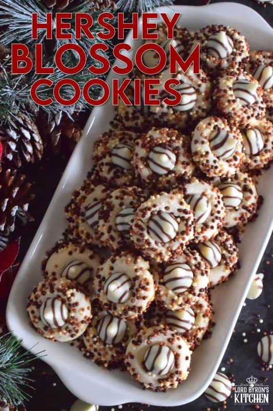 Christmastime is rushed and hurried, especially for the home cook, which leaves little time or desire for cookies that require chilled dough and rolling pins. Hershey Blossom Cookies are made with a whipped shortbread dough, rolled in sprinkles and dotted with a chocolate kiss. They're simple, beautiful, and delicious! Also, they're ready to eat in less than 30 minutes! #hershey #chocolatekiss #kiss #cookies #christmas #holiday #baking