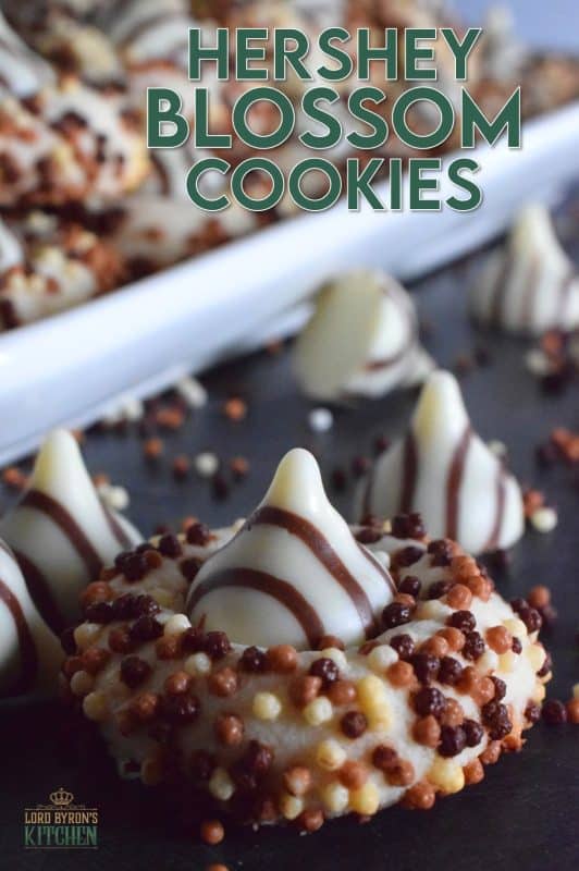 Christmastime is rushed and hurried, especially for the home cook, which leaves little time or desire for cookies that require chilled dough and rolling pins. Hershey Blossom Cookies are made with a whipped shortbread dough, rolled in sprinkles and dotted with a chocolate kiss. They're simple, beautiful, and delicious! Also, they're ready to eat in less than 30 minutes! #hershey #chocolatekiss #kiss #cookies #christmas #holiday #baking