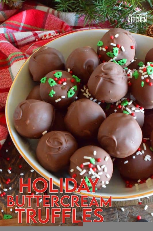 When it comes to truffles that melt in your mouth, Holiday Buttercream Truffles are the best! The bright white centers are prepared with cream cheese and butter, just like the beginnings of a good cake frosting! Dipped in melted milk chocolate, it's hard to eat just one of these! #truffles #buttercream #cookies #nobake #christmas #holiday #chocolate