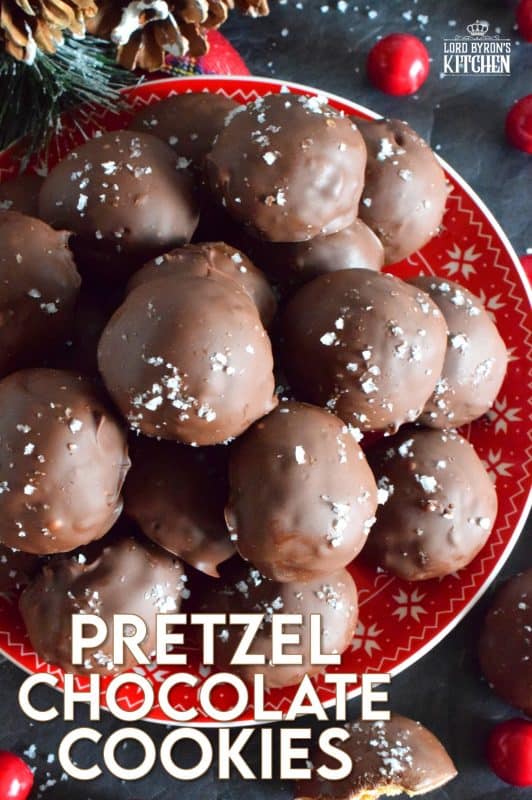 This is a cookie that has been baked into a ball and then dipped into melted chocolate and topped with flaked sea salt. If you love the combination of salty and sweet, than Pretzel Chocolate Cookies are for you! #christmas #holiday #baking #cookie #balls #chocolate #pretzels #cookieexchange