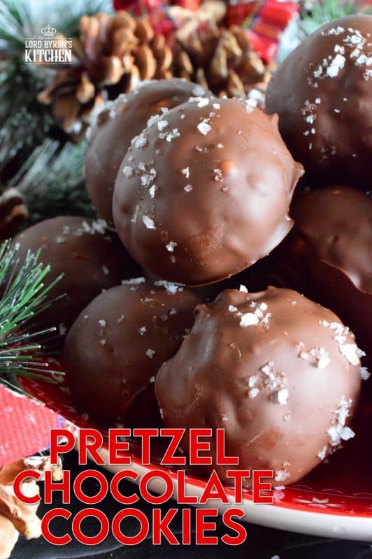 This is a cookie that has been baked into a ball and then dipped into melted chocolate and topped with flaked sea salt. If you love the combination of salty and sweet, than Pretzel Chocolate Cookies are for you! #christmas #holiday #baking #cookie #balls #chocolate #pretzels #cookieexchange