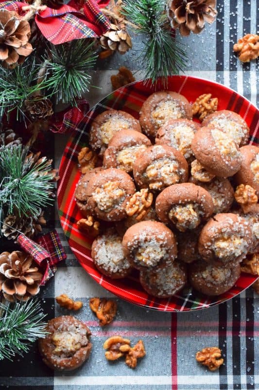 These chocolate cookies are baked with a whole candied walnut right in the center. The cookie is chocolatey and chewy, but the walnut is sweet and crunchy. Paired together, they make these Candied Walnut Cookies something extraordinary - despite the fact that they look like stuffed mushrooms! #walnuts #candied #christmas #candiednuts #baking #holiday