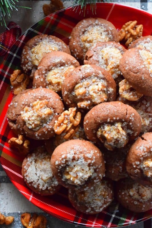 These chocolate cookies are baked with a whole candied walnut right in the center. The cookie is chocolatey and chewy, but the walnut is sweet and crunchy. Paired together, they make these Candied Walnut Cookies something extraordinary - despite the fact that they look like stuffed mushrooms! #walnuts #candied #christmas #candiednuts #baking #holiday
